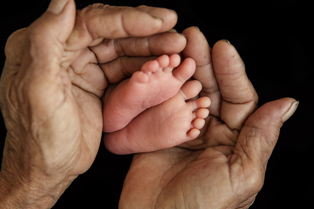 Close-up of baby's hand holding mother's finger (Soft focus and